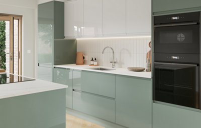 The Garcinia kitchen features gloss slab doors with integrated handles, creating a bright, modern look that reflects light beautifully across the space.