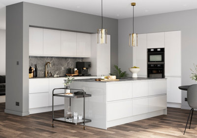 A large white and grey kitchen with wood effect laminate flooring.