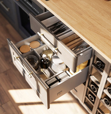 Close up of a kitchen drawer full of storage jars and containers, separated by drawer dividers.