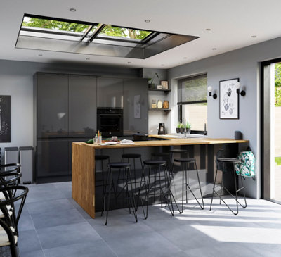 Large grey kitchen with plenty of natural daylight streaming in from two roof windows, a window on the wall, and a set of French doors.