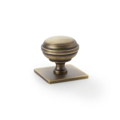 Alexander & Wilks Quantock Cupboard Knob on Square Backplate - Antique Brass - 34mm