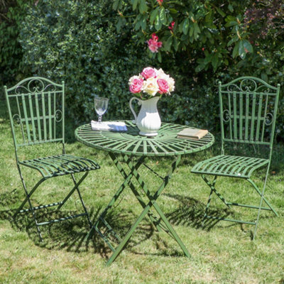 Green metal table and outlet chairs