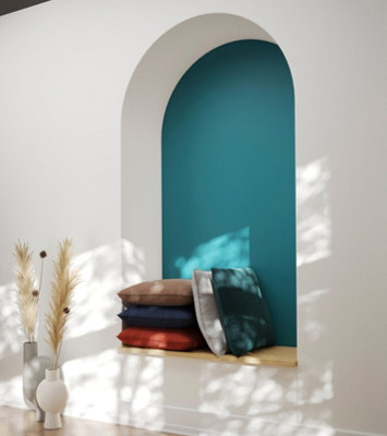 An arched alcove with built in bench and cushions.