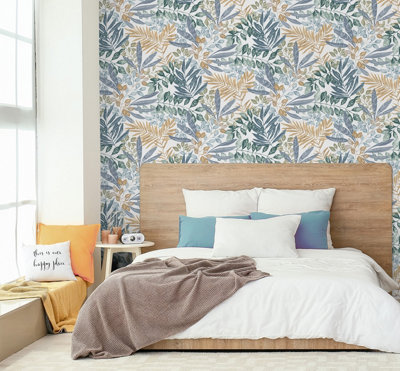 A modern bedroom with a large wooden bed, set against a wallpapered feature wall with a botanical leaf print in green, blue, and dark orange.