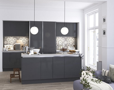 White and grey open plan kitchen lounge with handleless grey cabinets and white walls.