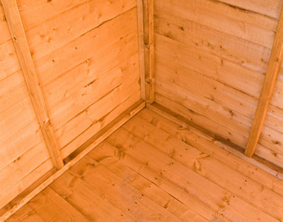A tongue and groove timber shed floor, featuring long, thin boards that are slotted together tightly.