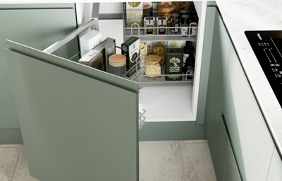 The Garcinia kitchen features matt slab doors with integrated handles in a soft green tone, creating a clean and contemporary finish.