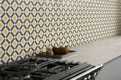 Yellow, grey and black geometric patterned kitchen splashback.