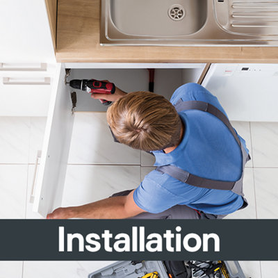 Installer using a power drill to fit a kitchen unit, with the word “Installation” overlaid on the image.