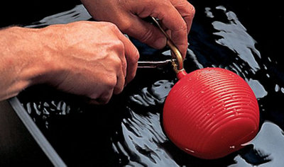 Person using a spanner to adjust a ball valve.