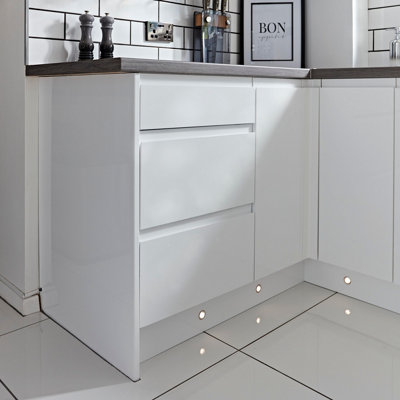 Spotlights at the base of modern kitchen cabinets