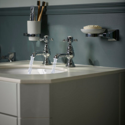 Traditional basin with wall hung soap dish and tooth brush holder above.