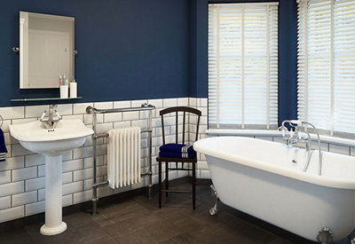 A traditional freestanding bath with ornate claw feet fitted to the bottom. Bath is installed in a traditional style bathroom.
