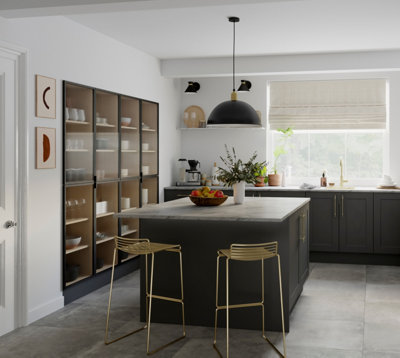 A large kitchen with a black and marble kitchen island with a statement black light fixture above the island.