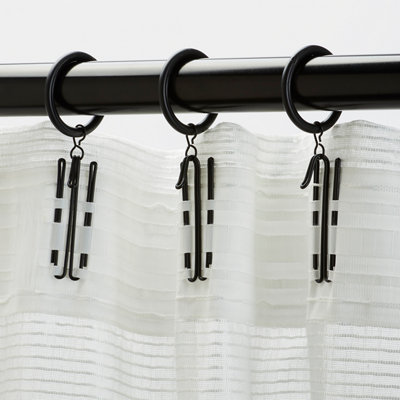White transparent curtains hanging in a living room.