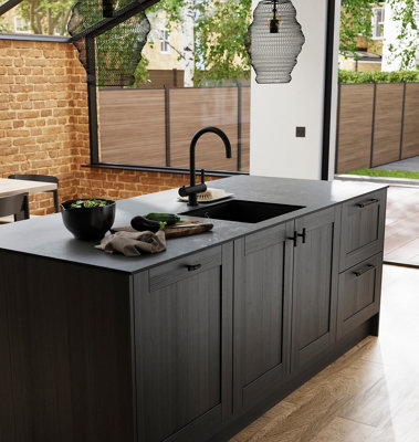 Black kitchen island with black tap and a black undermount sink.