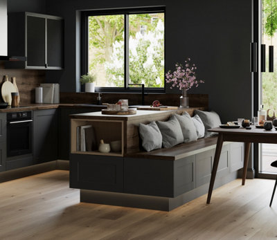 A black kitchen island with a built-in bench with an integrated shelf, adding extra storage space.
