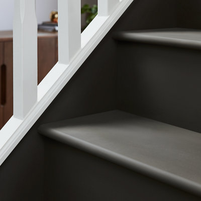 A black satin-painted staircase with a white bannister.