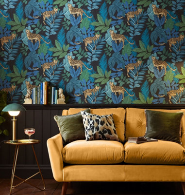 Bold blue and green cheetah print wallpaper in a living room with a statement yellow sofa.