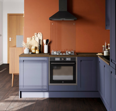A blue and orange kitchen with integrated appliances.