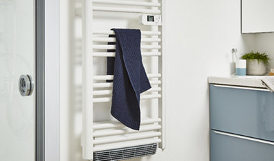 Electric towel rail with digital display installed in white bathroom.