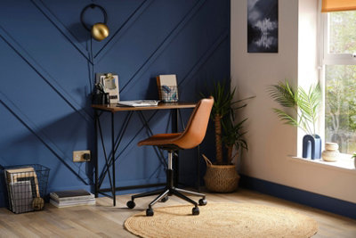 Blue feature wall with a chevron design in a home office.