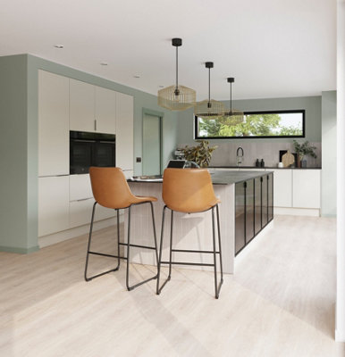 Large white and green kitchen with large kitchen island.