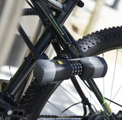 A bicycle locked up with a Yale black hardened steel combination D-lock.