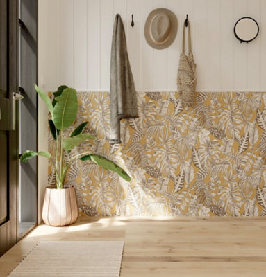 A welcoming hallway with light wooden flooring, featuring deep yellow botanical wallpaper on the lower half and white shiplap panelling on the upper half.