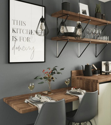 Grey galley kitchen with statement pendant lights above breakfast bar.