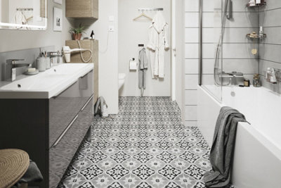 Grey, white and black mosaic pattern floor tiles in a bathroom.