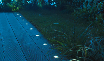 LED decking lights arranged in a straight line along garden decking.
