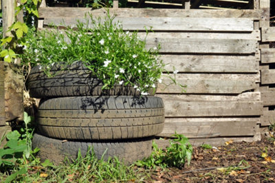 A large DIY planter made from used rubber car tyres.