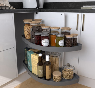Corner carousel kitchen cupboard full of jars of food and condiments.