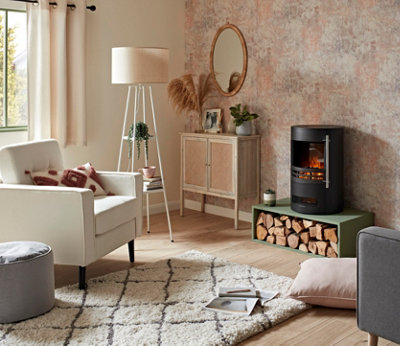 A cream and pink living room with cosy cushions and rug.