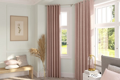 Cream panel mouldings in a bedroom furnished with pink curtains and accessories.