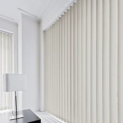 Vertical blinds made up of tall, thin horizontal slats installed on a large window in an office.
