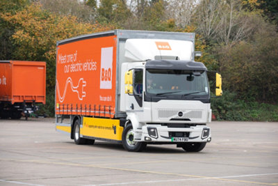 B&Q branded, electric HGV vehicle in a cark park.