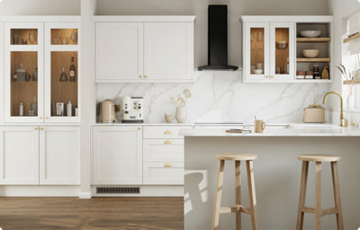 A U-shaped kitchen features shaker style cabinets in a soft, creamy white colour. Some of the cupboards have a glass-front with a warm wood interior on display. The countertops and splashback are white and grey marble-effect.