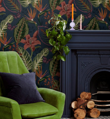 A dark blue and green living room with bold floral wallpaper.