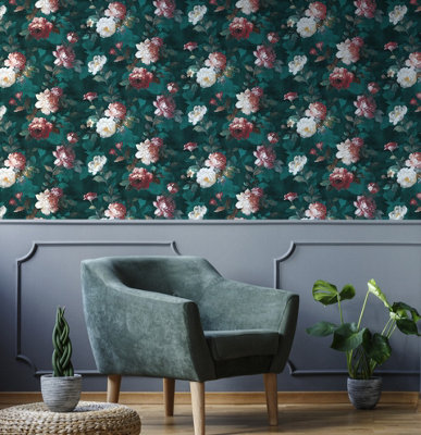 A dark green living room with floral wallpaper and a green upholstered armchair.