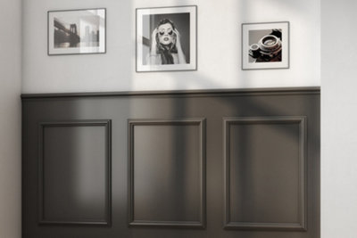White wall with dark grey wainscoting on lower half of the wall.