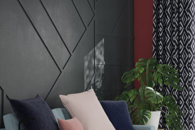 Dark grey geometric panelled feature wall in a living room.
