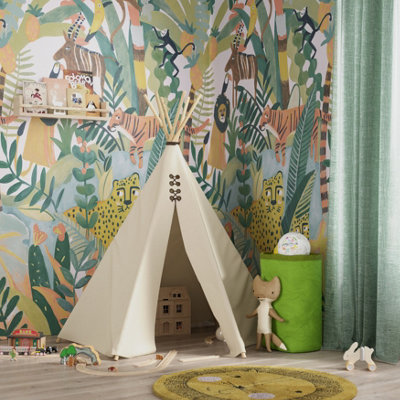 A nursery with a colourful jungle cat wallpaper featuring illustrated tigers, lions, and cheetahs, alongside a white teepee tent for a fun feel.