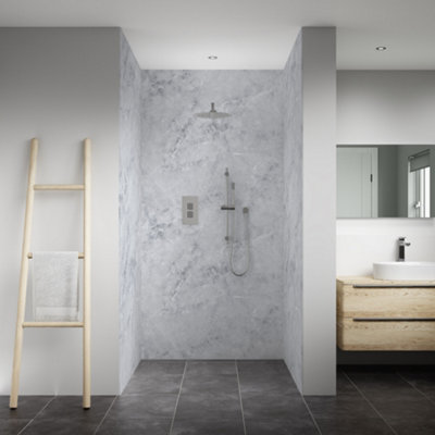 An alcove shower enclosure with a marble effect bathroom wall panel on the back wall.