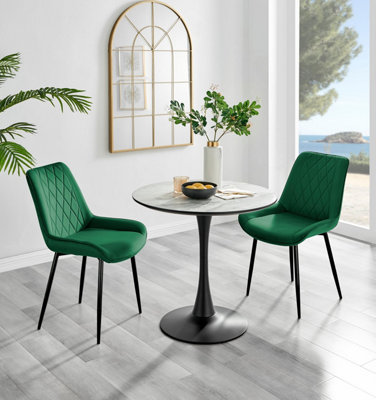 Elina White Marble Effect Round Pedestal Dining Table with Curved Black Support and 2 Green Velvet Pesaro Black Leg Chairs