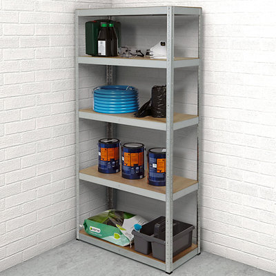 5 shelf metal garage shelving unit in front of white brick garage wall.