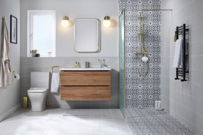 Wetroom shower enclosure with a mosaic tiled floor and walls, and a single shower screen.