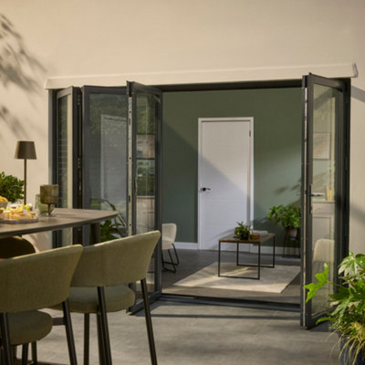 External view of black-framed, four part bifold doors that are half open.