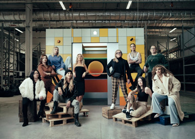 A group of female tradespeople posing in front of a lift as part of a new campaign with B&Q for International Women’s Day.